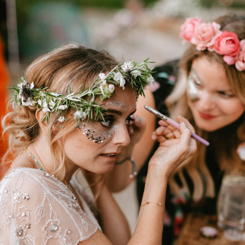 Bride in Jenny Packham Portia Wedding Dress and Flower Crown putting on Face Glitter