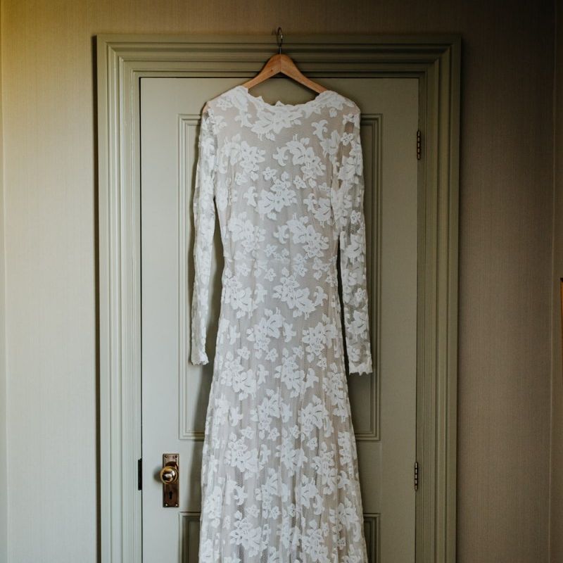 Laced long sleeve bridal dress at village hall wedding in Kent