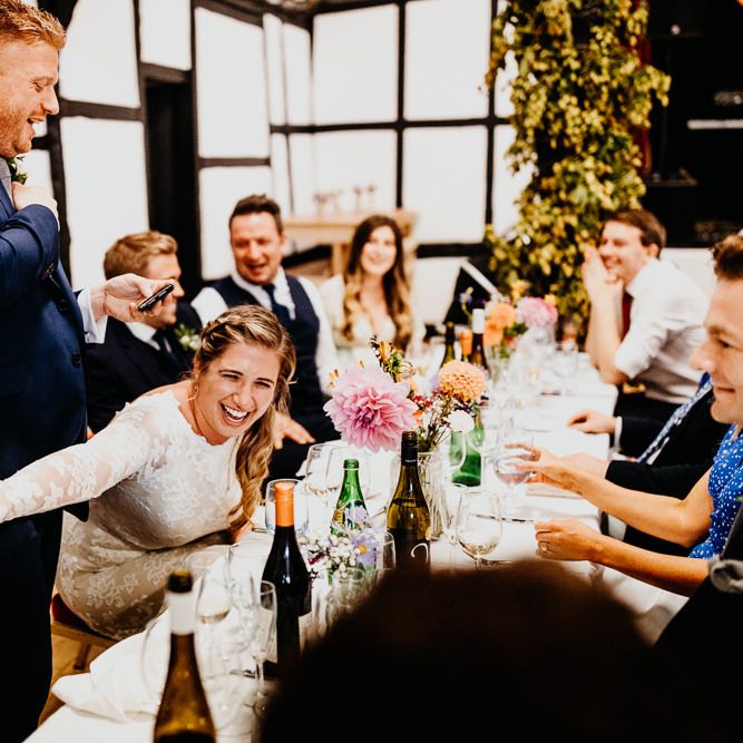 Grooms speech at wedding reception with colourful styling and hanging lanterns
