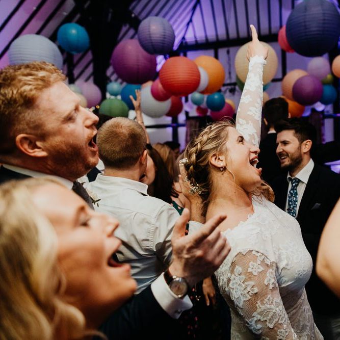 Bride and groom celebrate at their wedding with hanging lanterns decorations