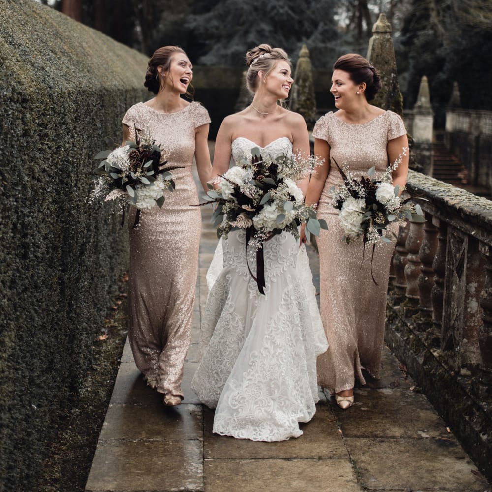 Bride &amp; Bridesmaids In Winter Wedding Attire // Bride In Alice Dress By Watters // Christmas Pub Wedding At The Falcon Rotherwick With Bride In Alice By Watters And Candle Lit Wedding Ceremony Images By Rebecca Searle Photography
