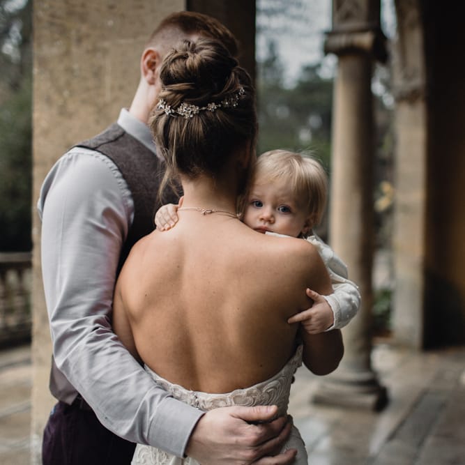 Bride &amp; Groom With Daughter // Christmas Pub Wedding At The Falcon Rotherwick With Bride In Alice By Watters And Candle Lit Wedding Ceremony Images By Rebecca Searle Photography