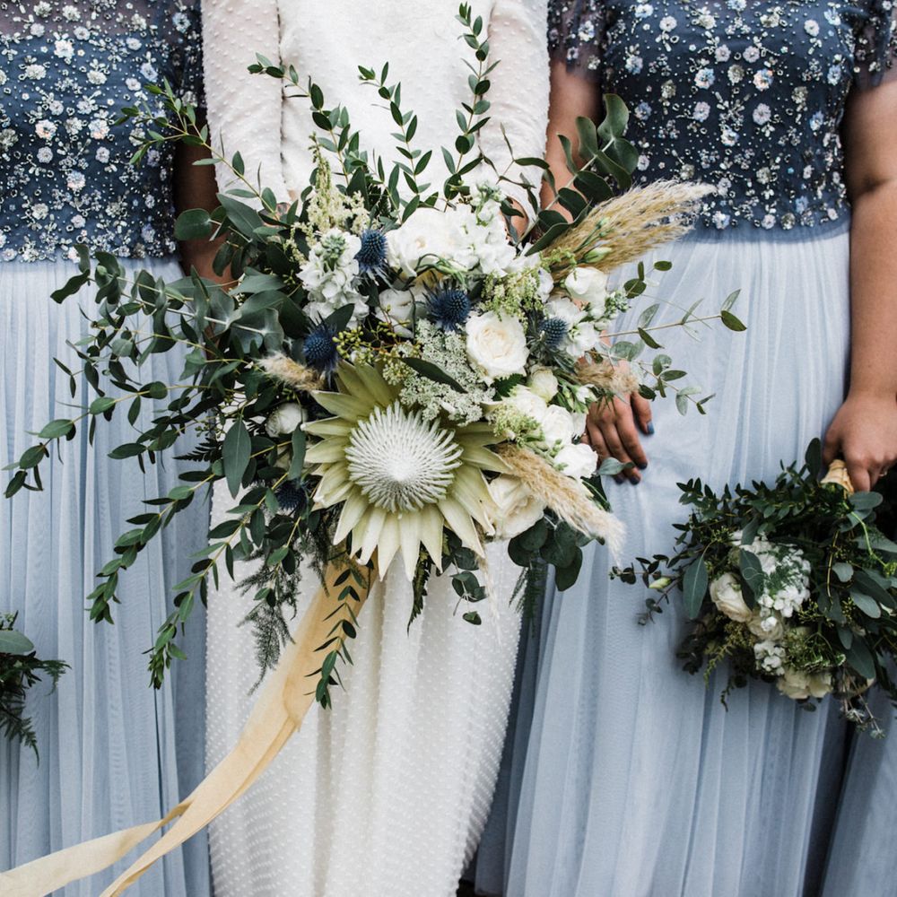 Bridesmaids and bride with creative wedding flowers
