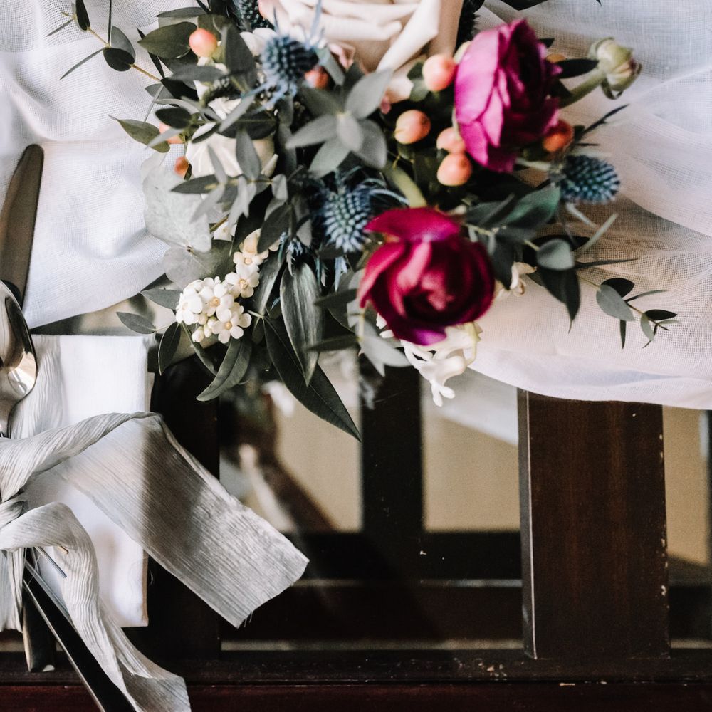 Cutlery tied with silk chiffon and wedding flowers
