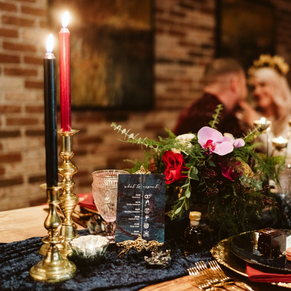 Red tablescape with bride and groom