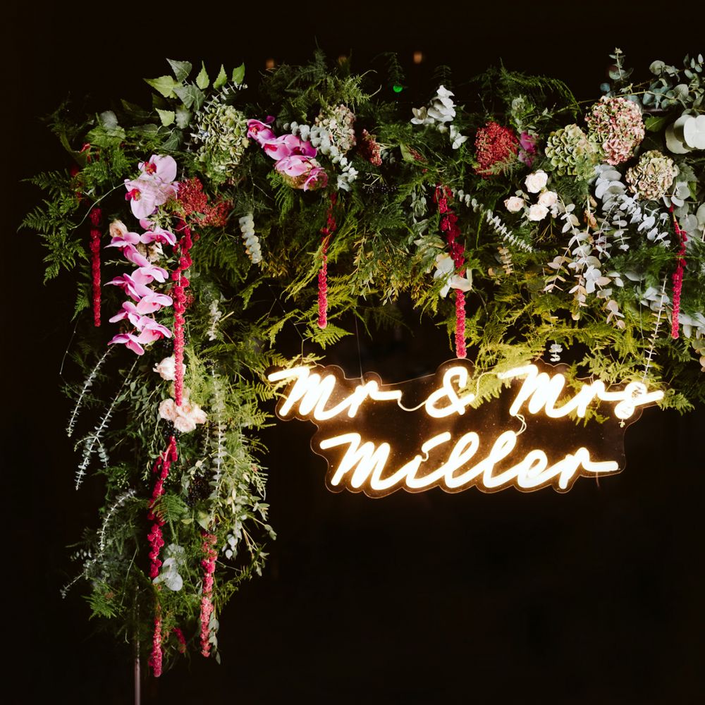 Neon sign with wedding flowers