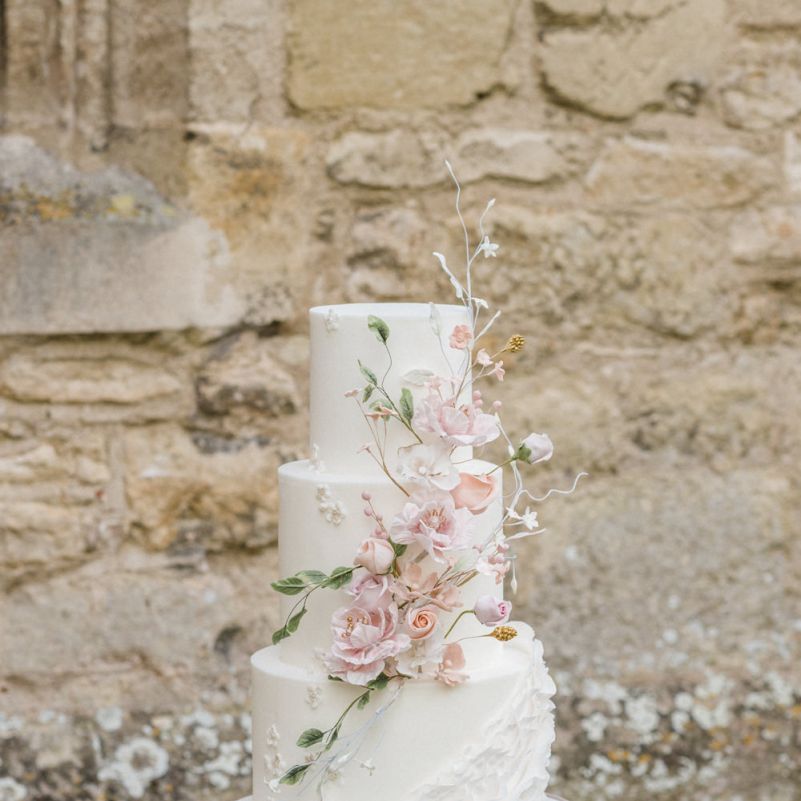 Elegant White Wedding Cake with Floral Decor