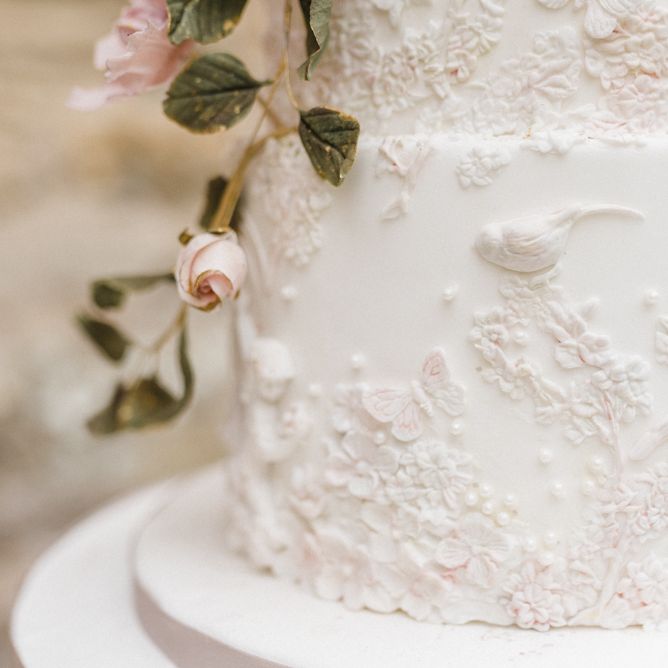 Elegant White Wedding Cake with Floral Decor by Gifted Heart Cakes