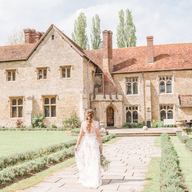 Bride in Floral Wedding Dress Walking Through Notley Abbey Country Gardens