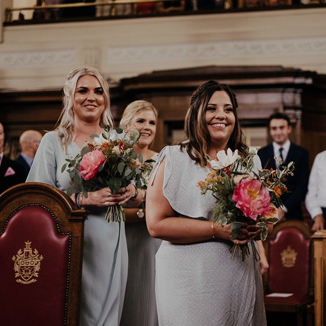 Bridesmaid walk up the aisle for ceremony