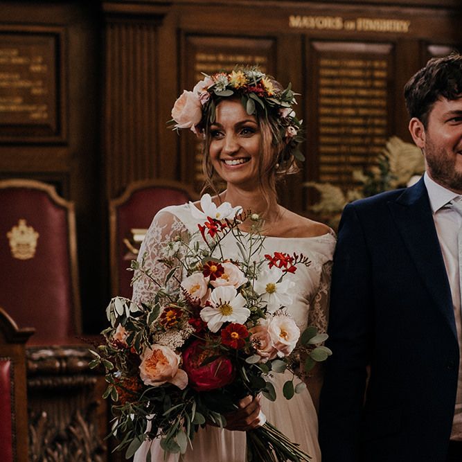 Bride and groom make their way out of Islington town hall wedding ceremony