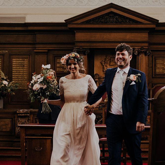 Bride and groom make their way out of Islington town hall wedding ceremony