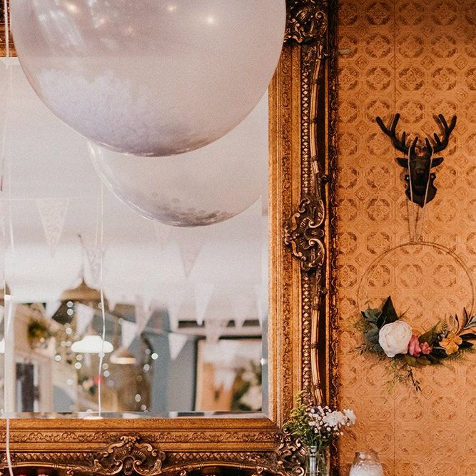 Wedding decor ideas with flower hoops and confetti balloons