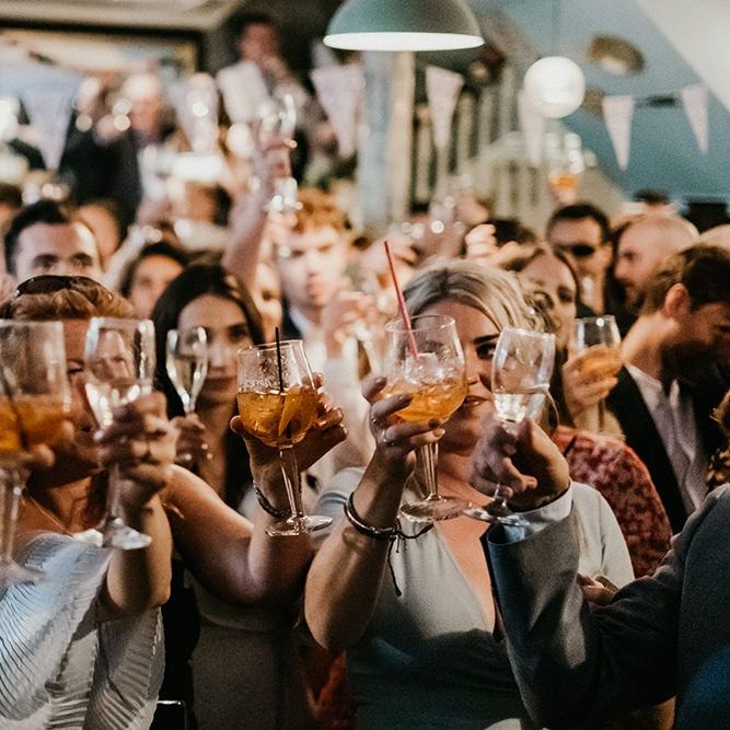 Guests cheers at pub wedding