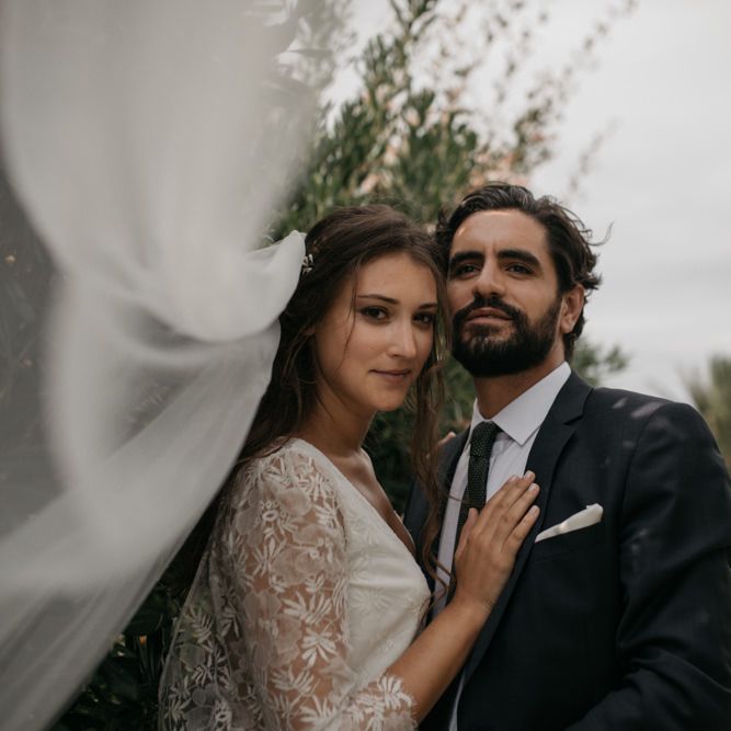 Bride in Donatelle Godart Wedding Dress &amp; Veil with Bearded Groom in De Fursac Suit