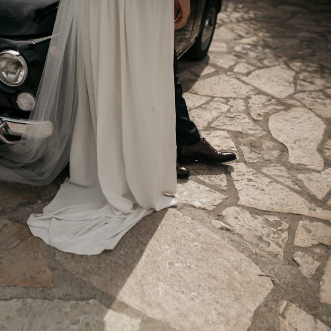 Bride in Donatelle Godart Wedding Dress Standing Next to a Fiat 500 Wedding Car