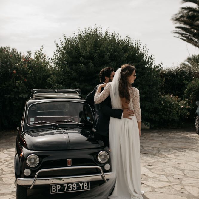 Bride in Donatelle Godart Wedding Dress &amp; Groom in De Fursac Suit Standing Next to a Fiat 500 Wedding Car
