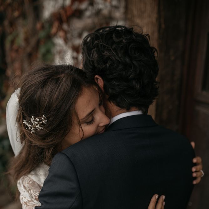 Bride in Donatelle Godart Wedding Dress &amp; Groom in De Fursac Suit Embracing