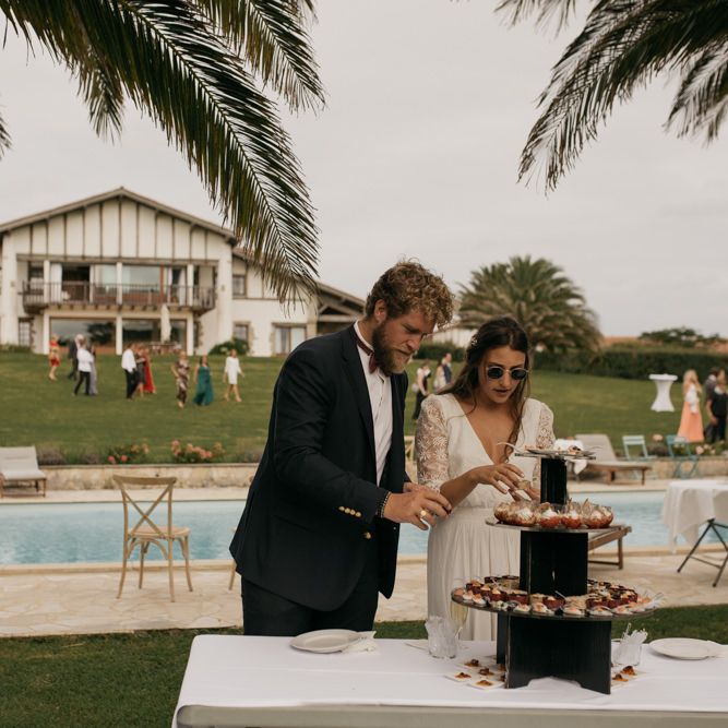 Bride in Donatelle Godart Wedding Dress at Poolside Drinks Reception