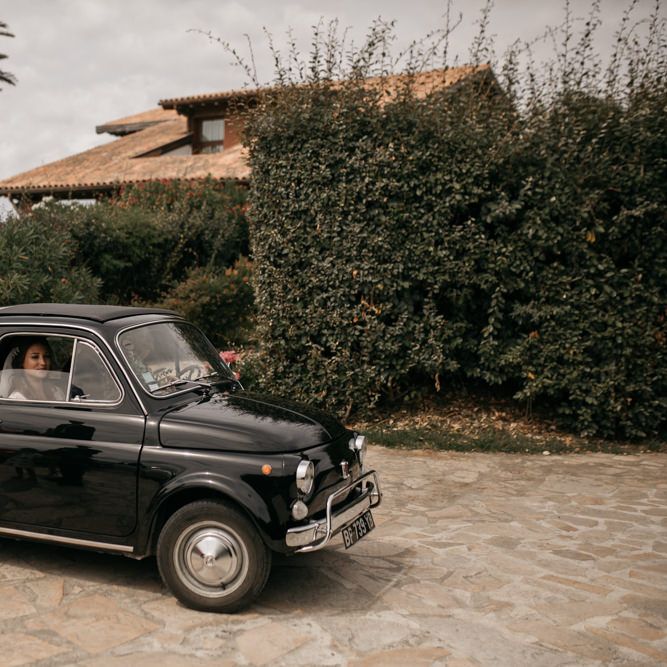 Bride in Donatelle Godart Wedding Dress inside Black Fiat 500 Wedding Car