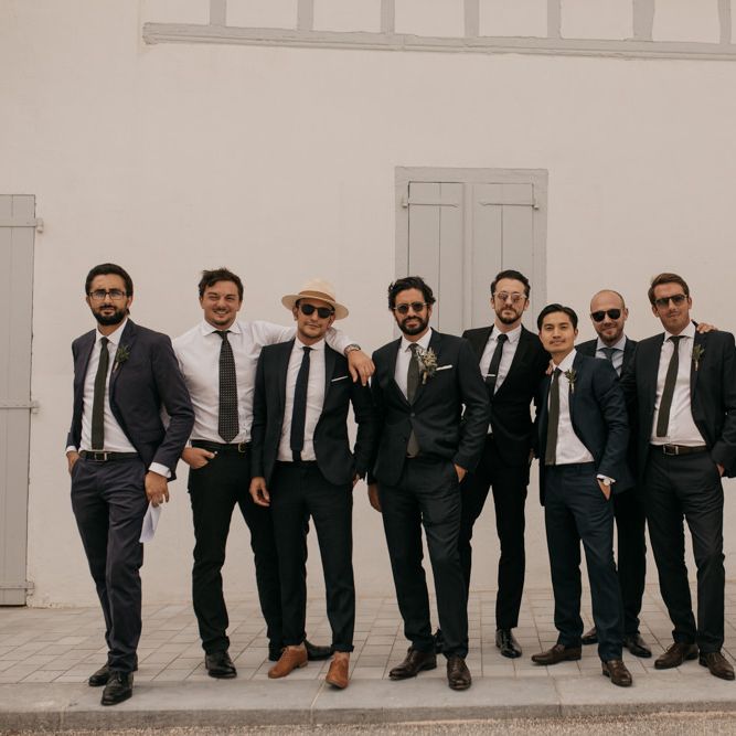 Stylish Groom in Black De Fursac Suit with Groomsmen