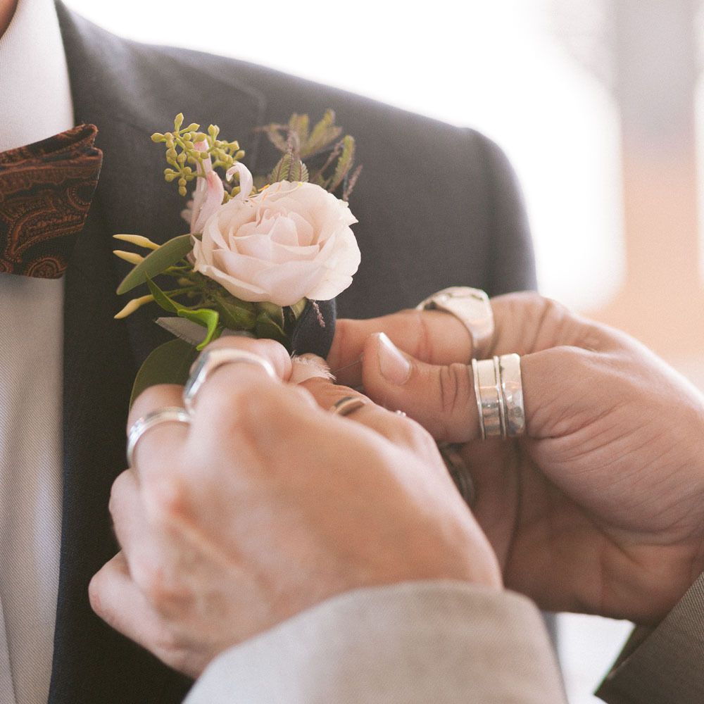 Blush rose buttonhole for groom in bowtie