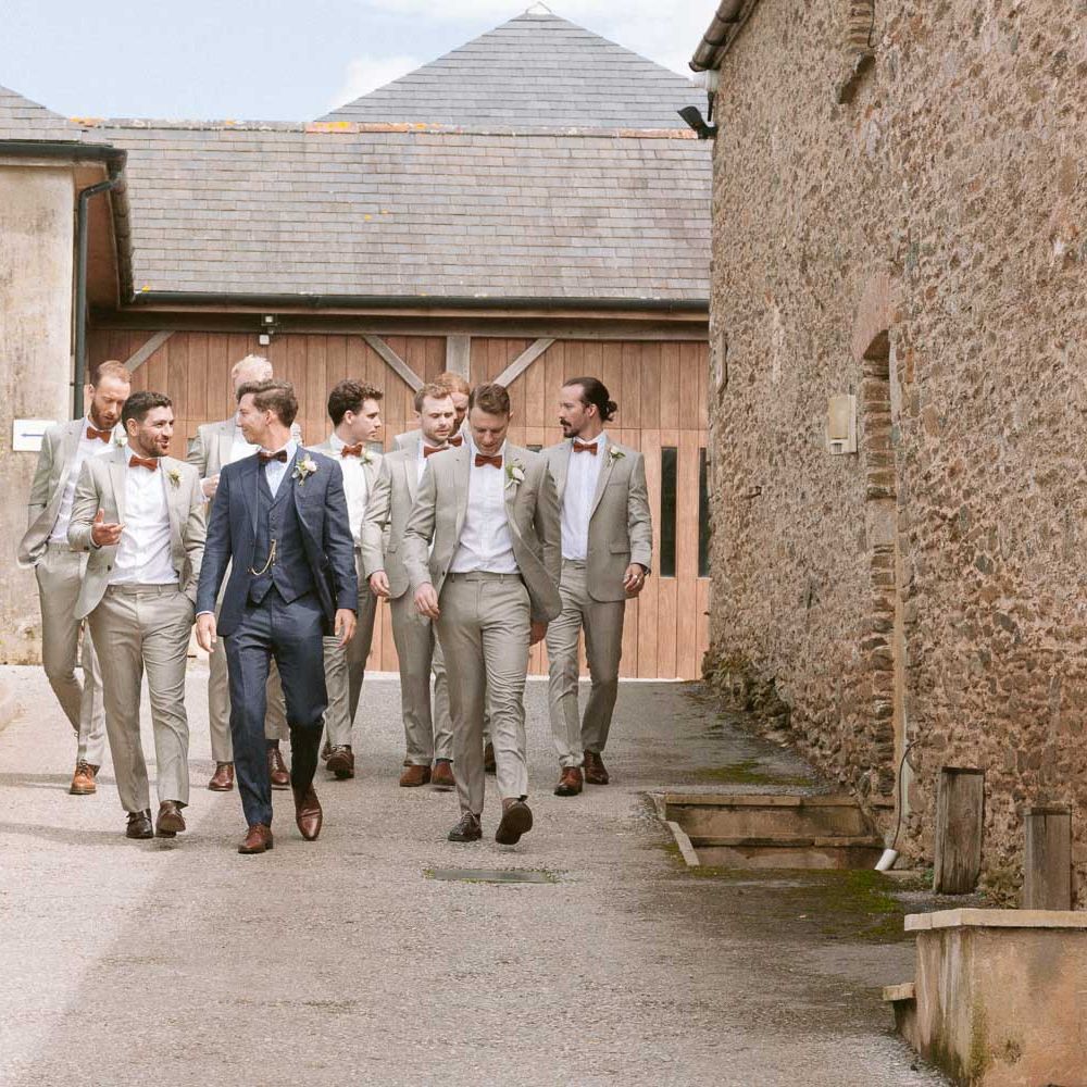 Groom with groomsmen wearing matching suits and bowties at Shilstone House wedding