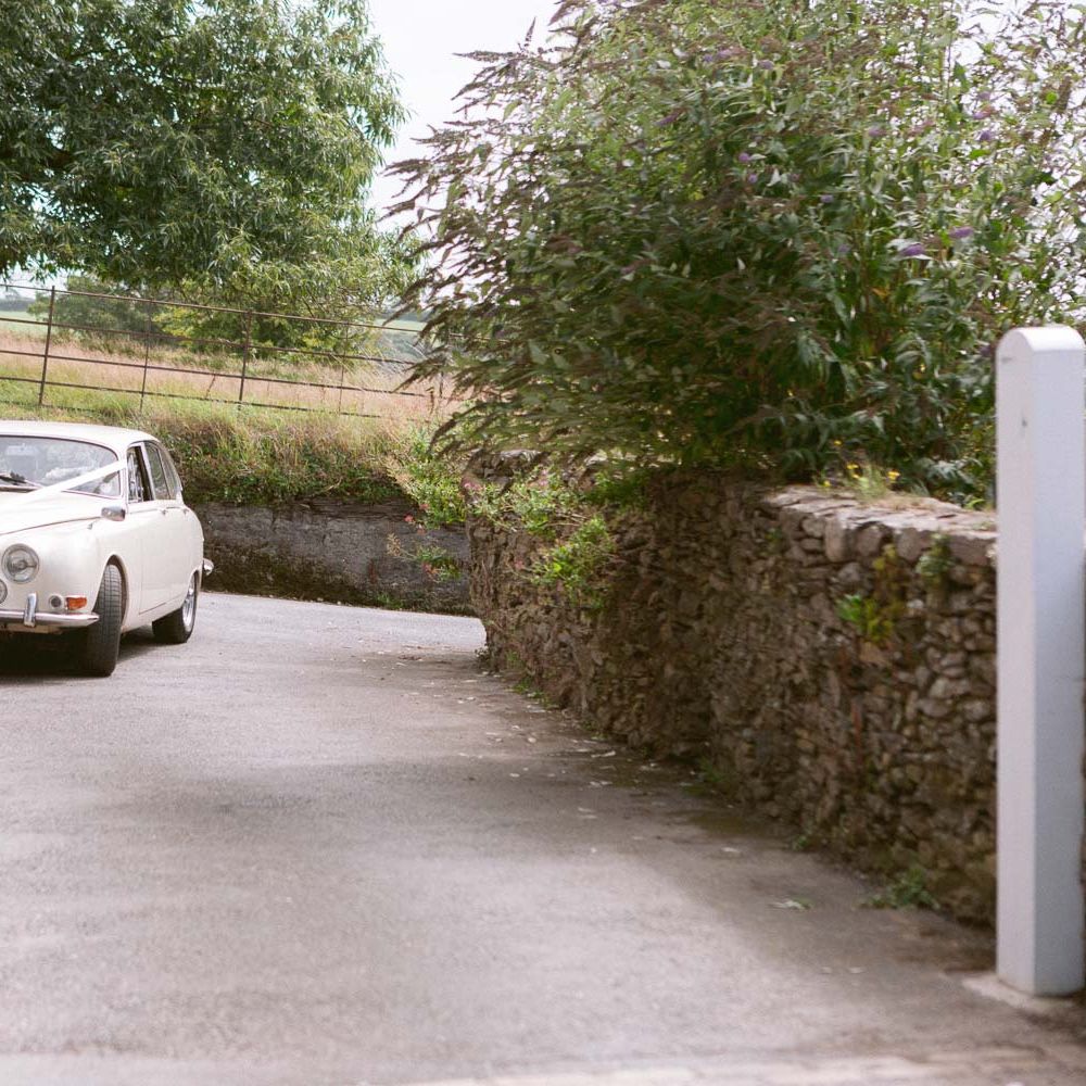 Vintage wedding car arriving at Shilstone House wedding ceremony