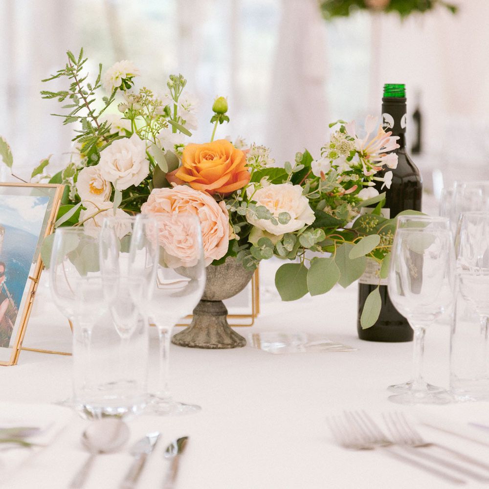 Table centrepieces with blush and peach roses