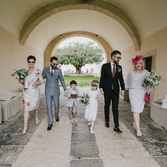 Grooms and family arrive at wedding ceremony