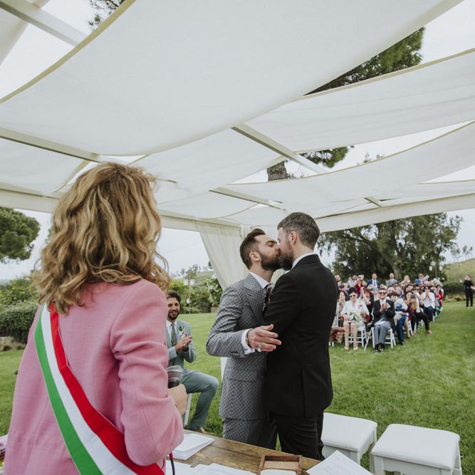 Groom and groom kiss