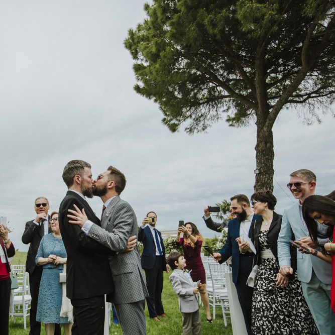 Grooms kiss after wedding ceremony