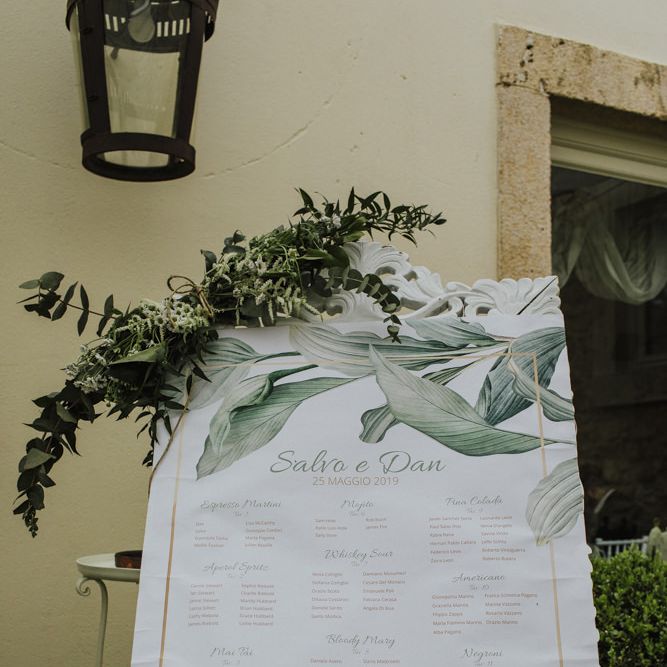 Wedding table seating plan with olive branch decor