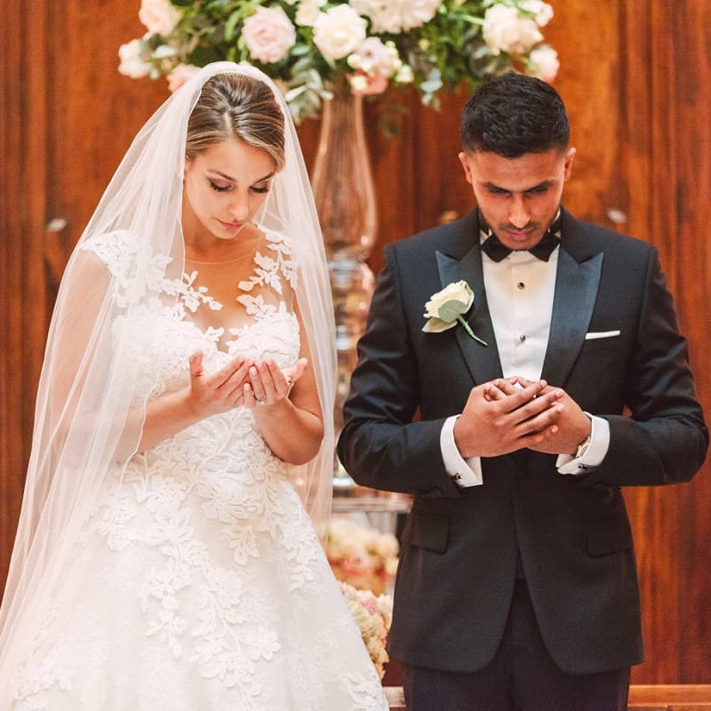 Bride in Lace Princess Wedding Dress and Groom in Tuxedo During Their Wedding Ceremony