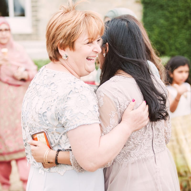 Mother of The Bride and Wedding Guest Embracing