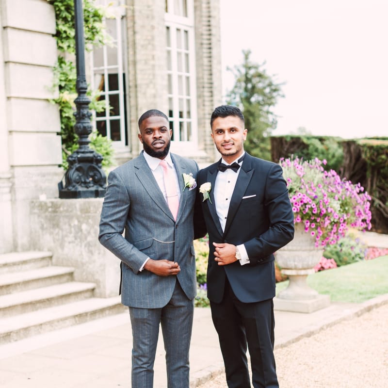 Groom in Black Tie Suit and Groomsman in Grey Suit