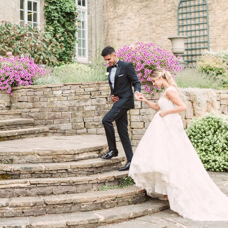 Bride in Lace Pronovias Wedding Dress and Groom in Black Tie Suit