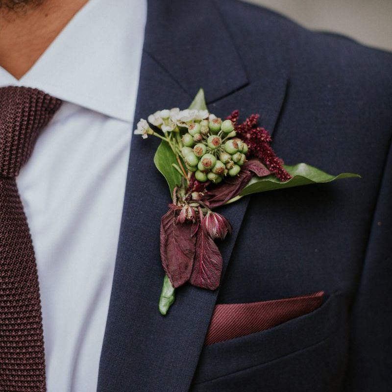 Berry buttonhole with deep red foliage