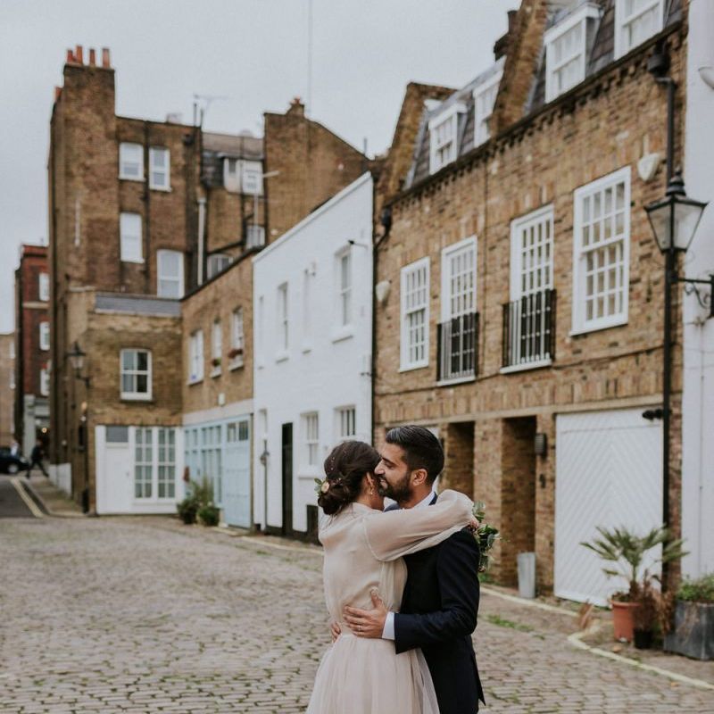 Bride and groom embracing in London Streets