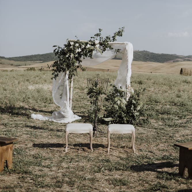 Wedding ceremony decor with flowers and drapes