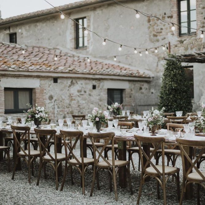 Outdoor wedding breakfast with festoon lighting