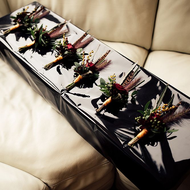 Box of Groomsmen Buttonholes with Foliage, Red Rose and Pheasant Feather