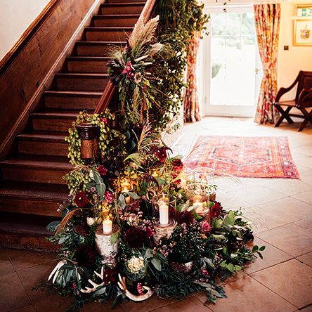 Staircase Wedding Floral Arrangement with Foliage, Red Flowers, Pampas Grass and Pheasant Feathers