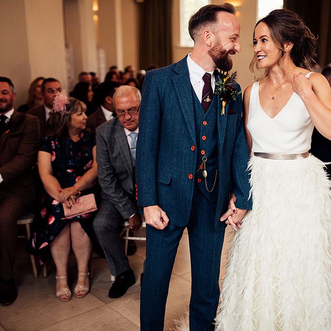 Bride in Charlie Brear Payton Bridal Gown &amp; Piora Feather Skirt at The Altar with Her Groom