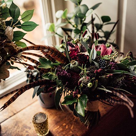 Foliage,  Red Flowers and Pheasant Feather Floral Arrangement