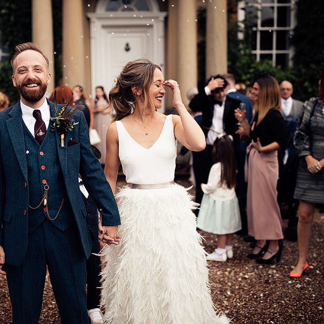 Confetti Moment with Bride in Charlie Brear Payton Bridal Gown &amp; Piora Feather Skirt and Groom in Three Piece Wool Suit