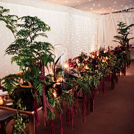 Top Table Wedding Floral Arrangement including Foliage, Red Flowers  and Candle Light