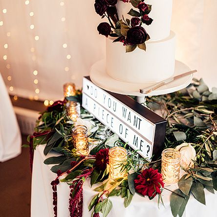 Elegant Wedding Cake with Floral Skirt and 'Do You Want a Piece of Me' Light Box Sign