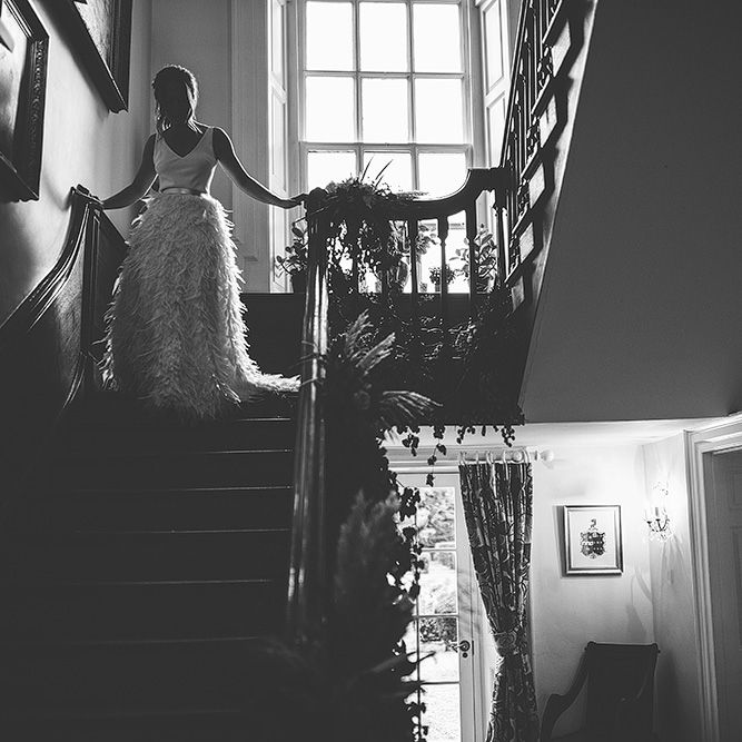 Bride Walking Down the Stairs  in Charlie Brear Payton Bridal Gown &amp; Piora Feather Skirt