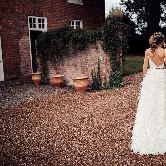 Bride in a Charlie Brear Payton Bridal Gown &amp; Piora Feather Skirt and Groom in a Wool Suit